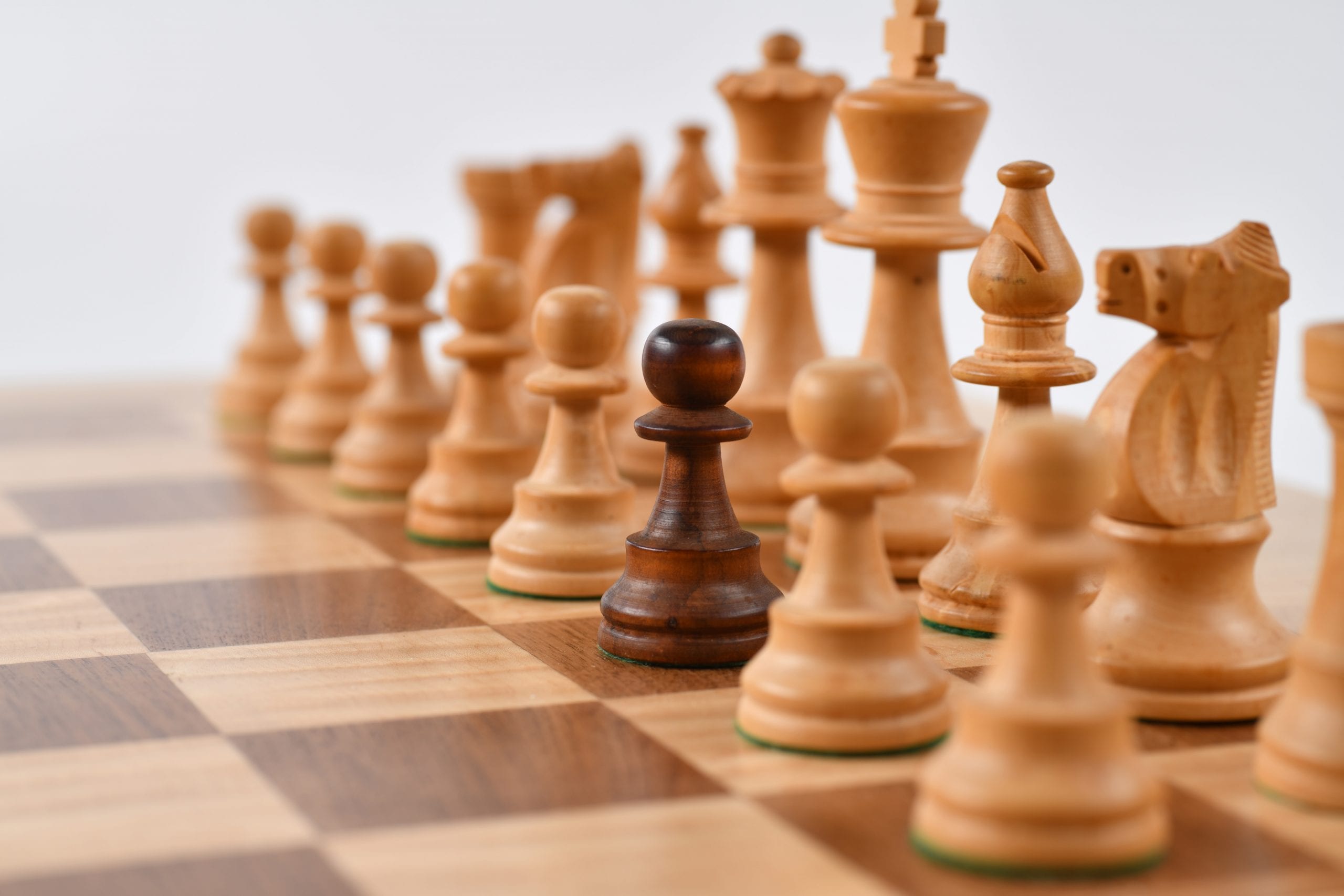 One Black Pawn around a White Set of Chess Pieces